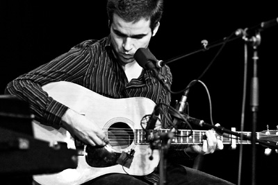 robert coyne performing with a guitair